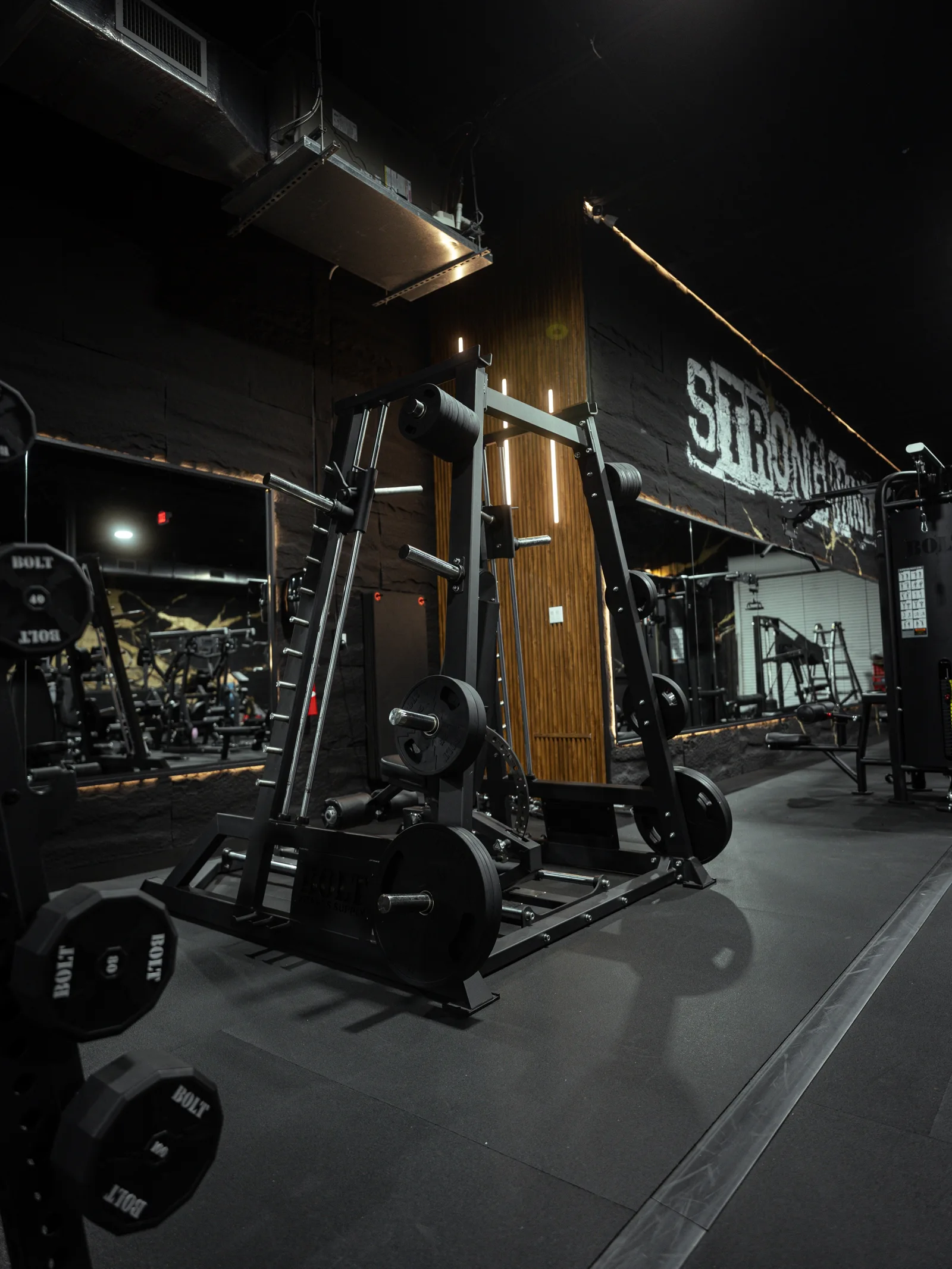 Strength equipment and warm lighting inside The OG House warehouse gym